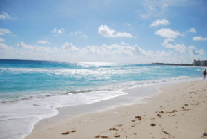 footprints in the sand on tropical Caribbean Beach ocean view