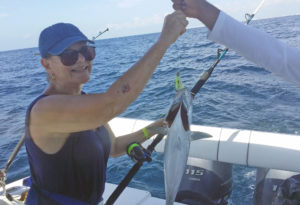My mom enjoying a deep sea fishing experience in Cancun, featured in the Ultimate Guide to Deep Sea Fishing.