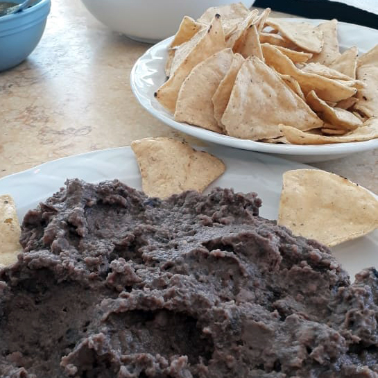 refried beans served with chips and salsa
