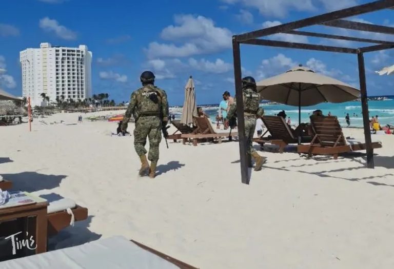 Security guard walking on the beach at our resort, highlighting security at Tim’s Ocean Condos in Cancun.