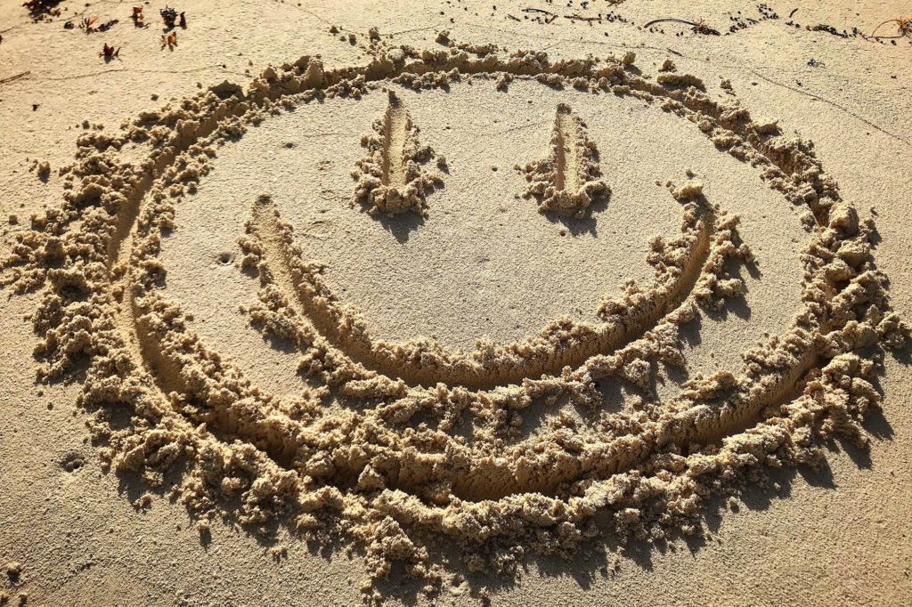 happy face in the sand in Cancun Beaches