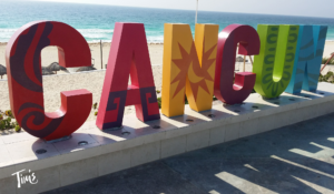 Plan your Cancun vacation with a visit to the famous CANCUN sign at Playa Delfines, featuring bold colors and a stunning ocean backdrop.