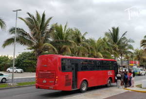 ADO R1 Red Bus picking up outside Tim's Ocean Condos in Cancun