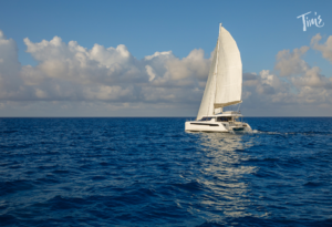 Private catamaran cruise in Cancun with clear blue water, perfect for guests of Tim’s Ocean Condos