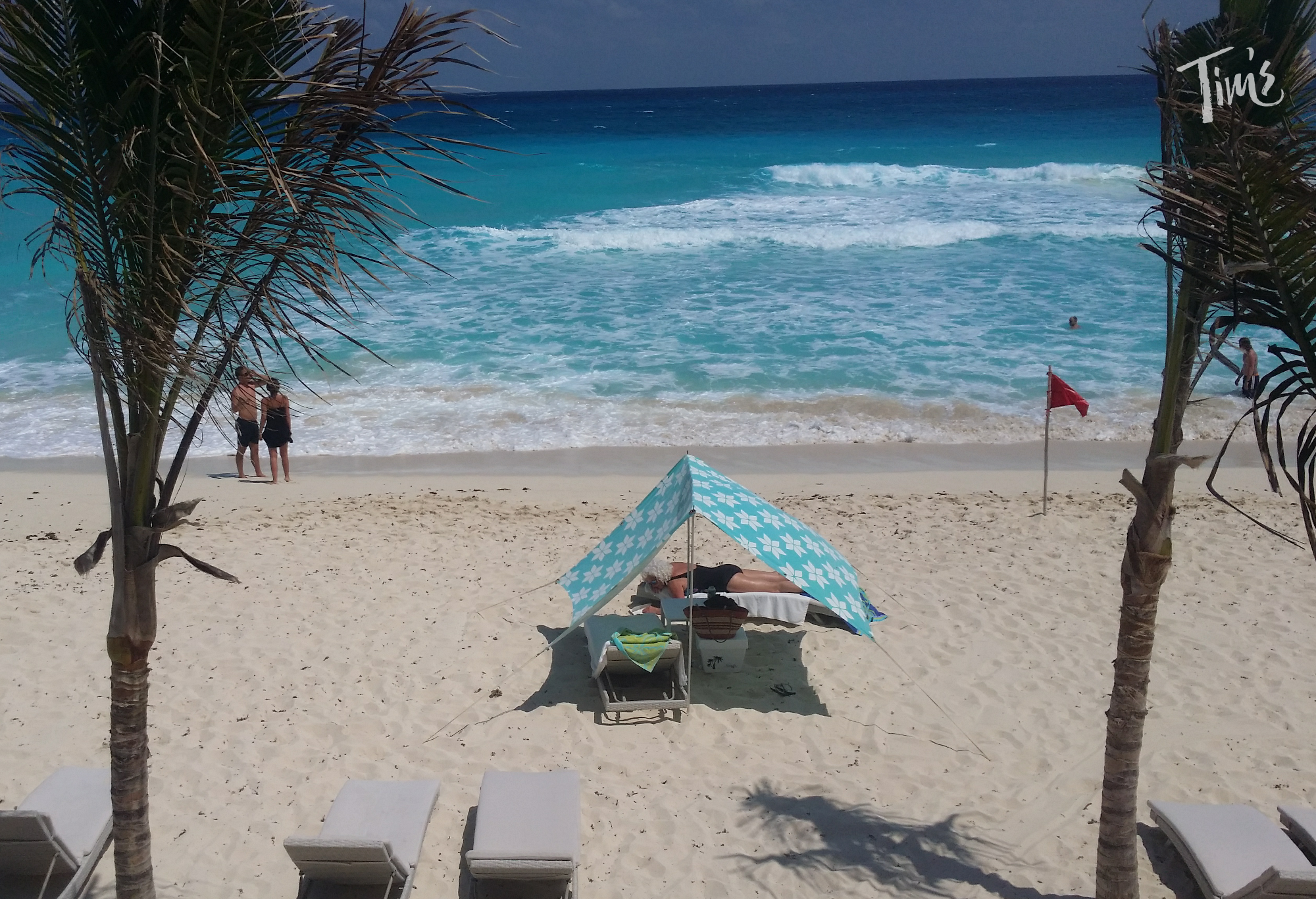 cancun beach with people walking oceanside