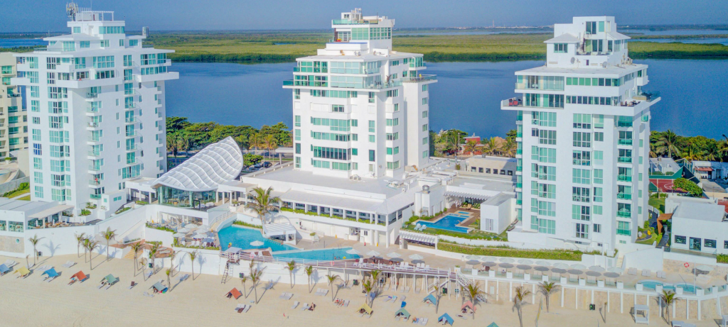 Drone view of Yalmakan’s three towers in Cancún, with the lagoon in the background.