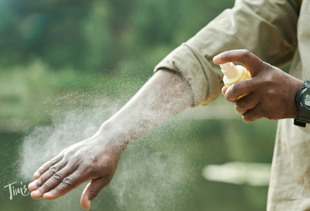 Guest at Tim’s Ocean Condos in Cancun applying mosquito repellent spray before going outside.