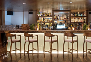 Elegant bar area at Tora Cancun with sunset lighting and signature cocktails.
