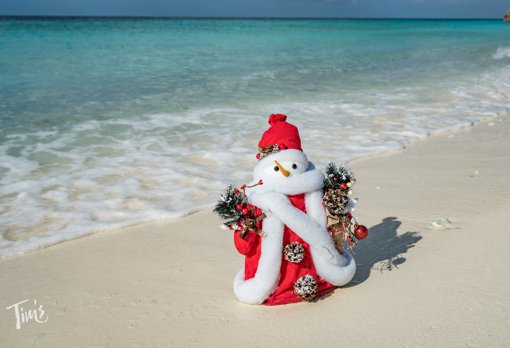 Santa decoration on the beach in front of the ocean at Tim’s Ocean Condos in Cancun.