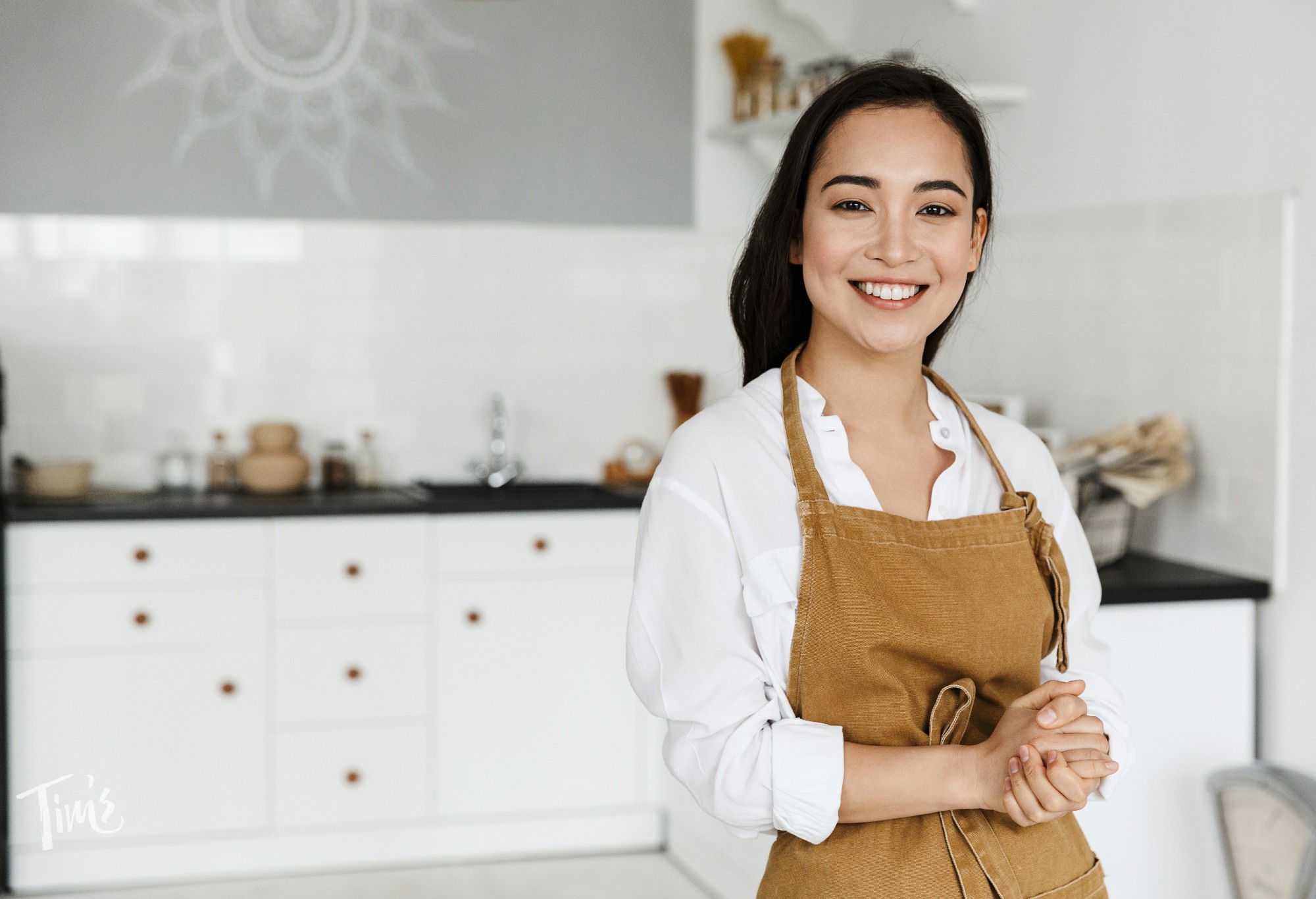 Private chef preparing a fresh meal in a penthouse kitchen for guests at Tim's Ocean Condos vacation rental Cancun