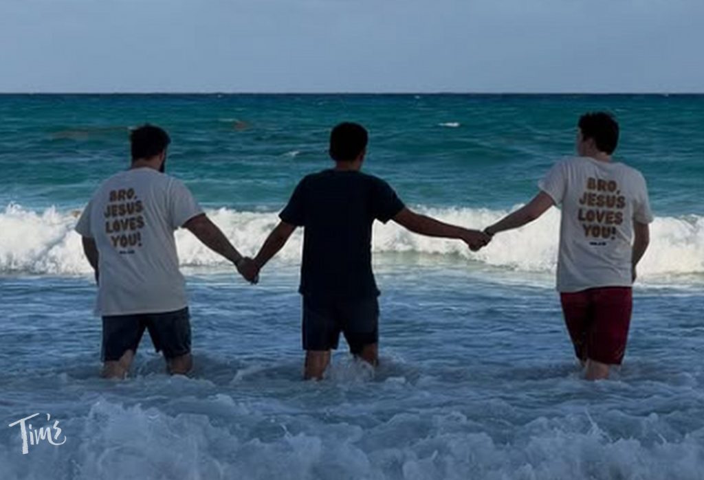 THE FOUR outreach team leading man into ocean for baptism in Cancun during spring break 2026