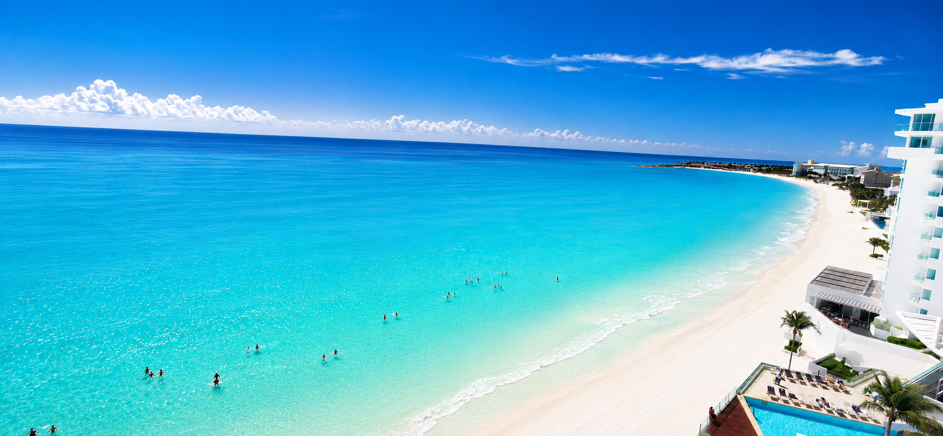 Panoramic view of Cancun's Hotel Zone with crystal-clear turquoise Caribbean water, pristine white sand beach, and guests enjoying the calm ocean near Tim's Ocean Condos.